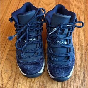 Jordan’s Navy Blue High-Top Sneakers with Lace-Up Design